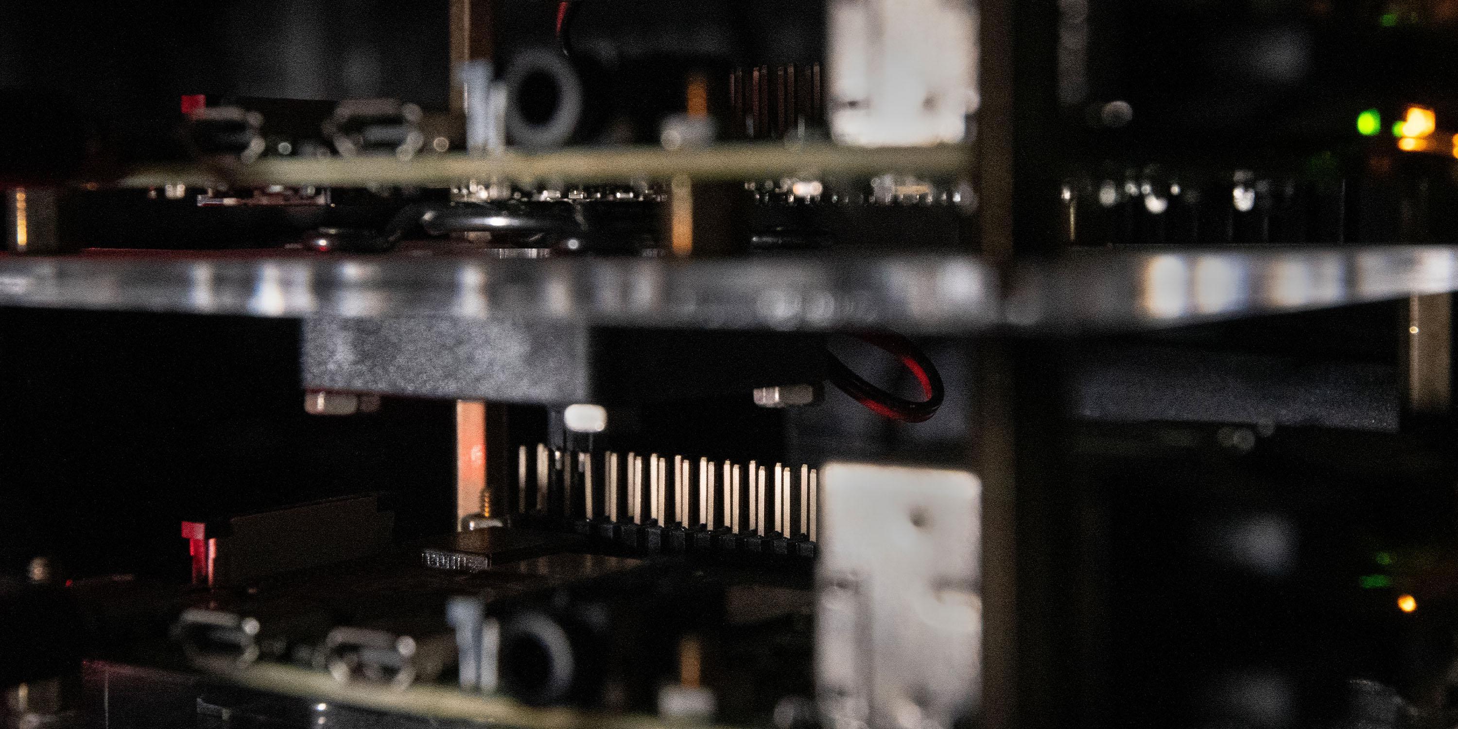 Close-up of vertically stacked single-board computers with visible connectors, components, and indicator lights.